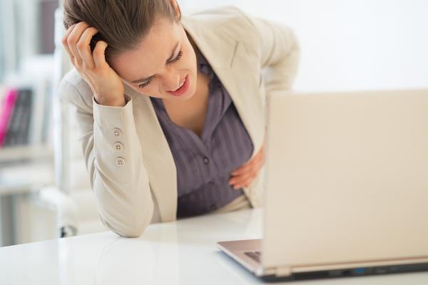 woman with stomach pain at work