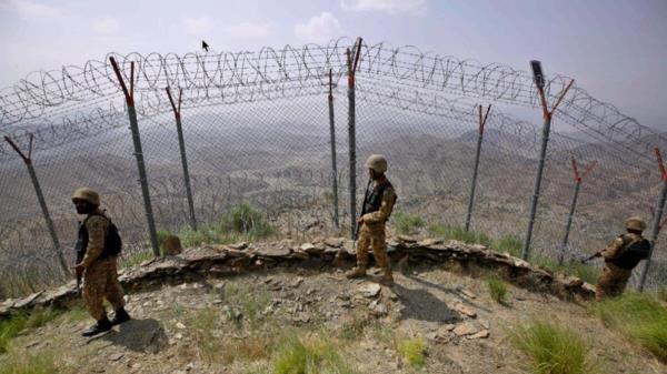 Pakistan Army troops patrol along the fence on the Pakistan Afghanistan border in Khyber district. — AP file
