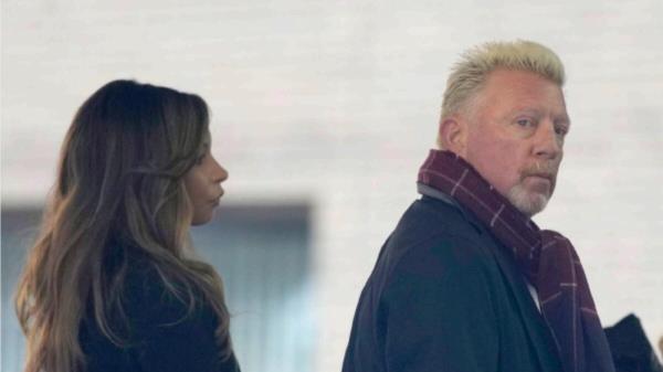 Former Wimbledon tennis champion Boris Becker, right, looks back as he waits in a queue to get into Southwark Crown Court in London. — AP